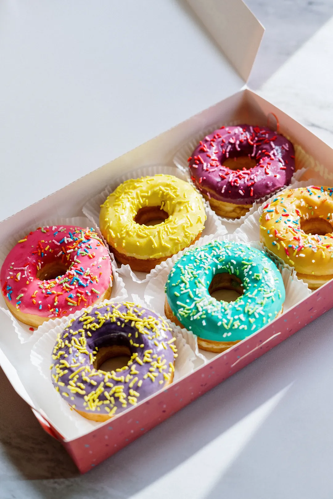 Colorful doughnut photo beside the Glaze and Grain bakery website example