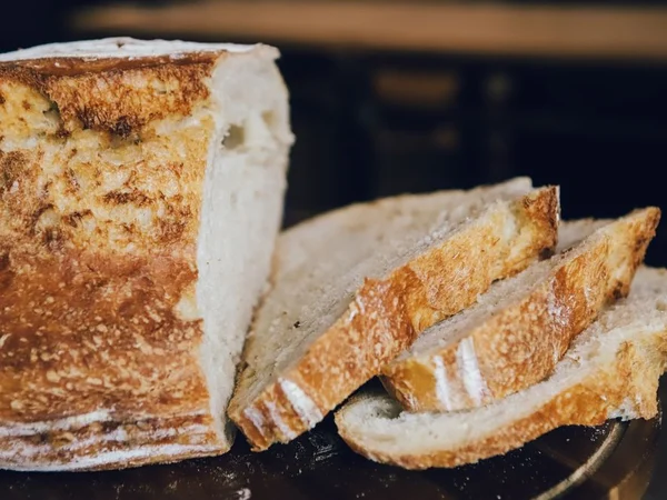 Sourdough loaf with golden crust and dark scoring