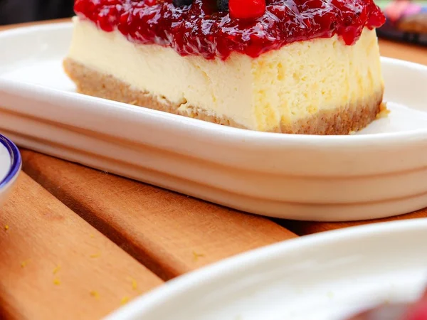 Berry cheesecake with a golden crust and dark red berry topping