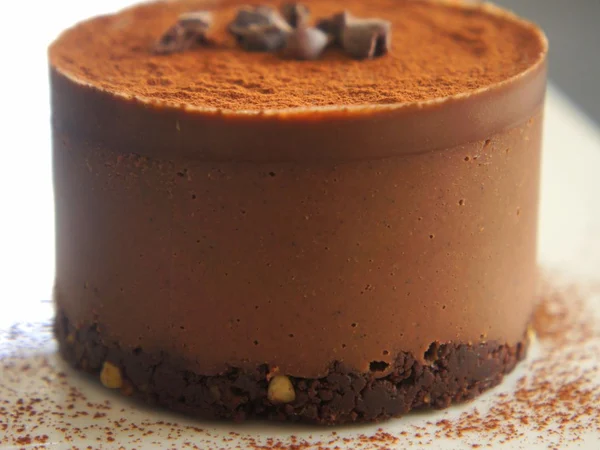 Chocolate mousse cake with brown chocolate layers and pale topping