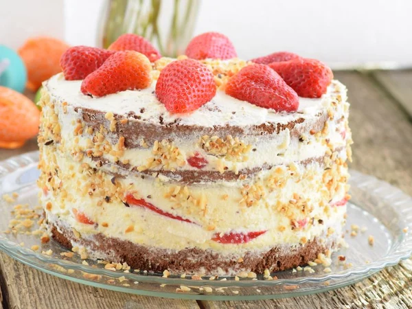 Strawberry cream cake with pink-red fruit and pale icing
