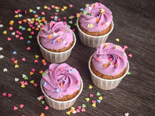 Pink buttercream cupcakes with warm brown cake tones