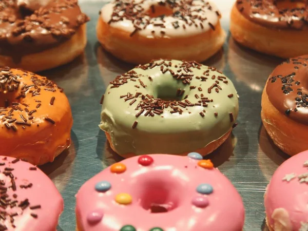 Iced donuts with orange, red and warm cream colors